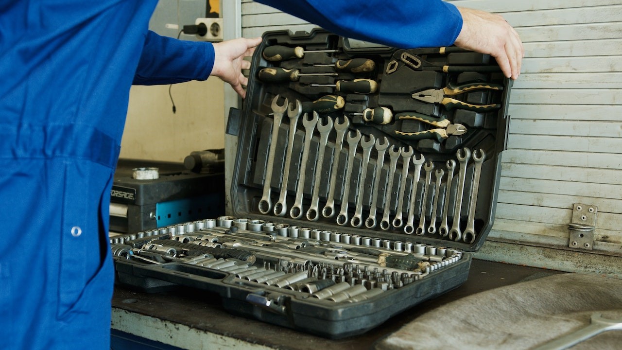 A Person Holding a Set of Tools in a Toolbox | Goodwill Car Donations