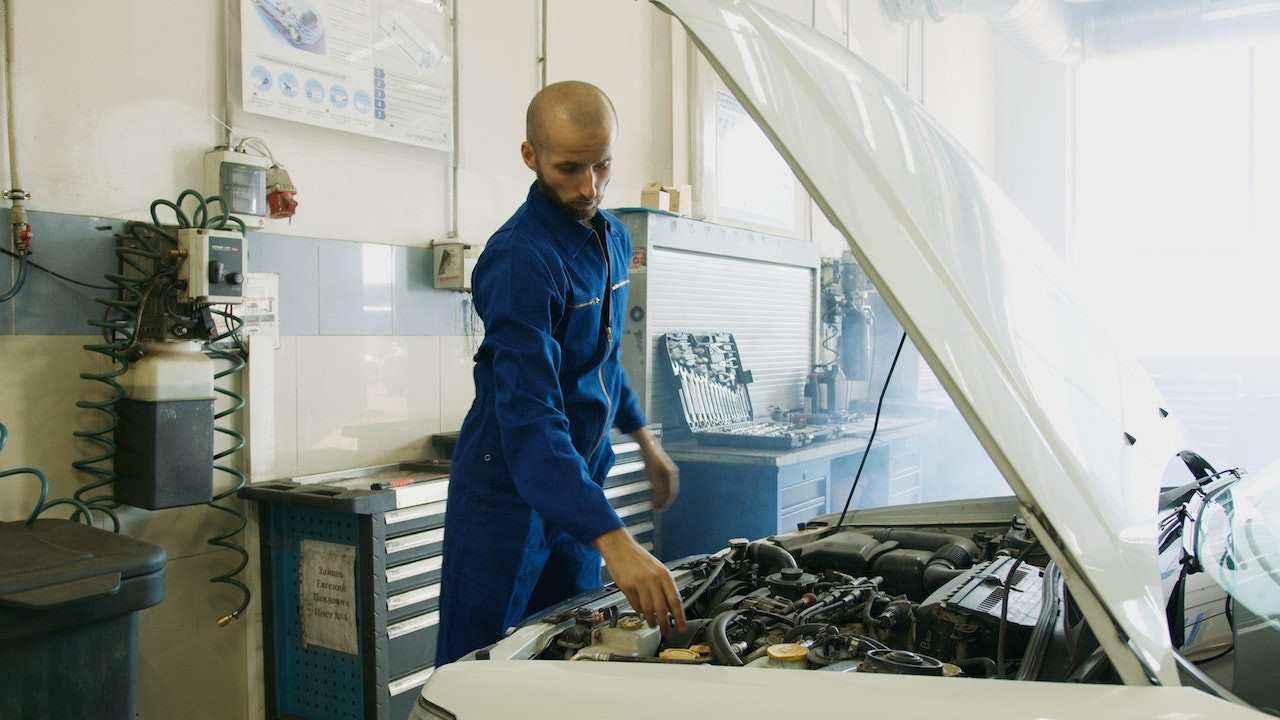 Mechanic Looking at the Engine of the Car | Goodwill Car Donations