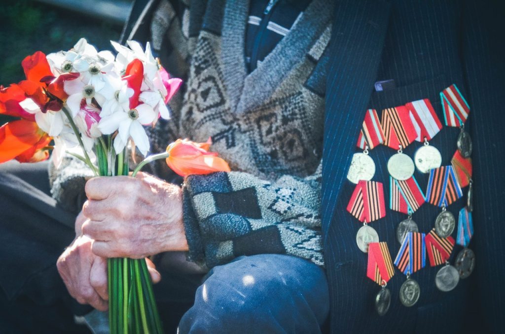 US Veteran Holding Flowers | Goodwill Car Donation