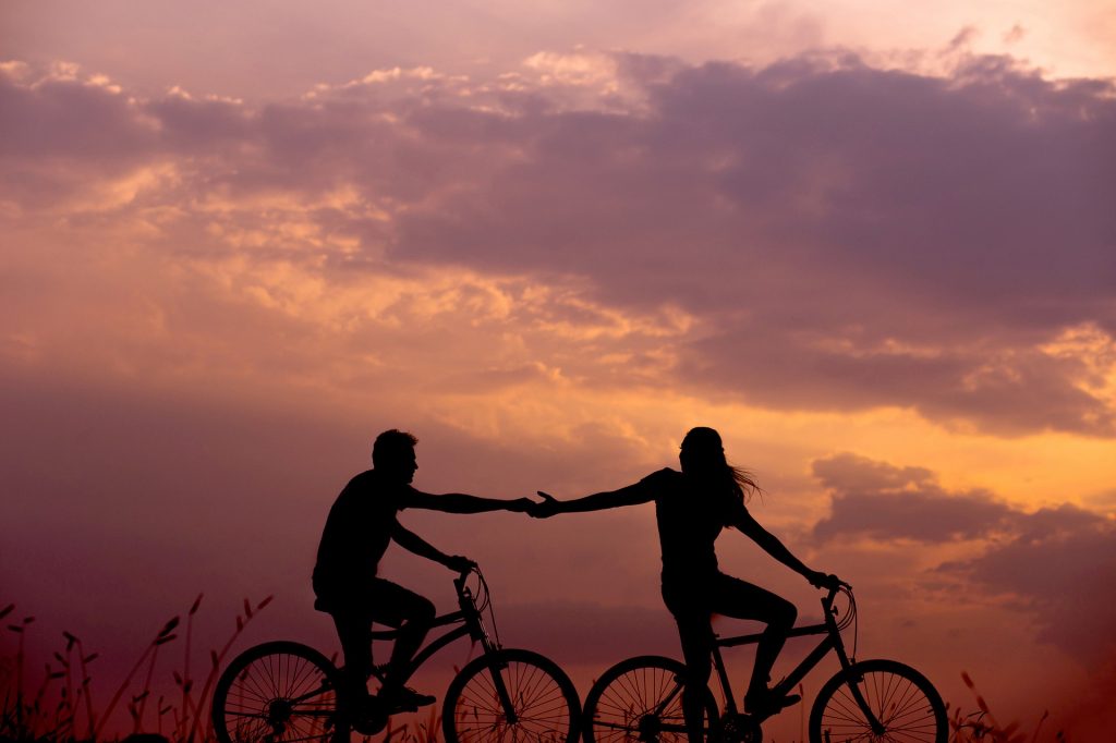 Friends Biking under the Sunset | Goodwill Car Donations