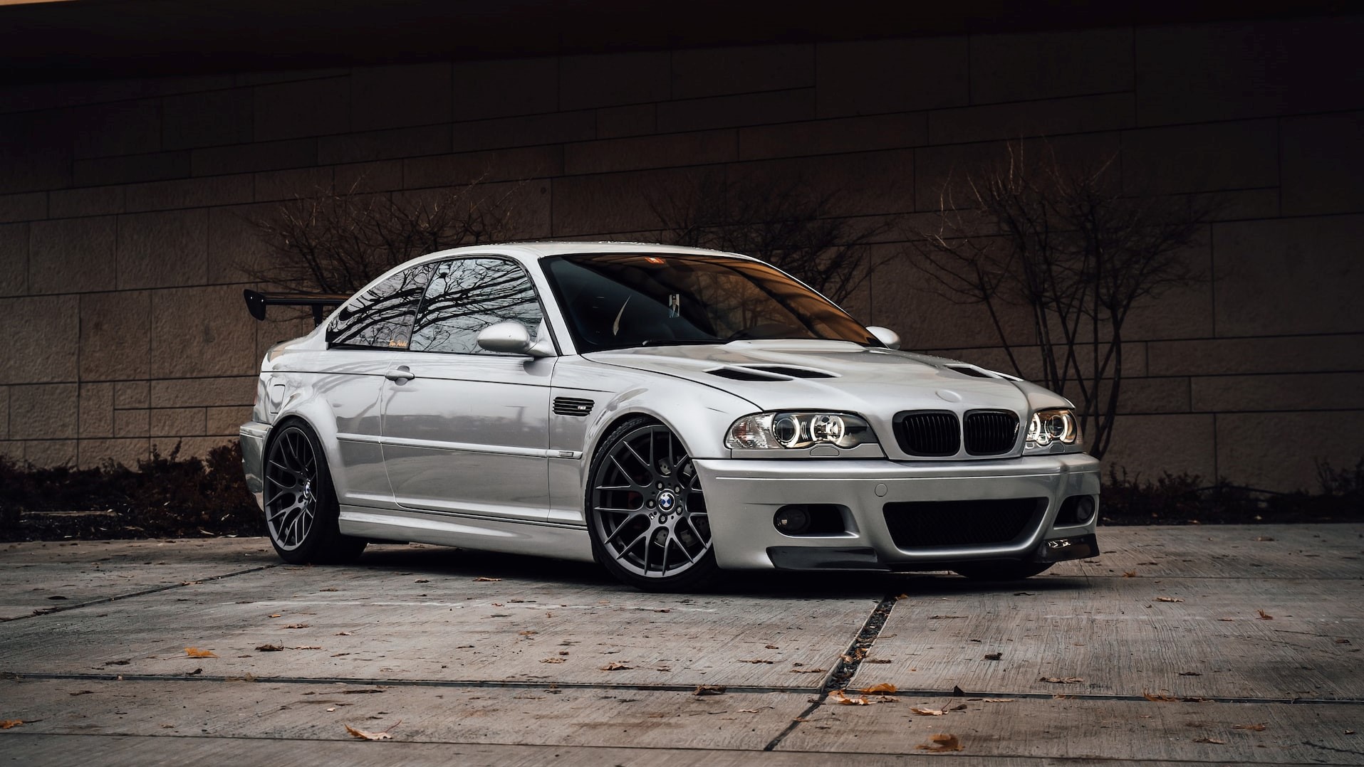 Silver bmw parked beside irange wall | Goodwill Car Donations