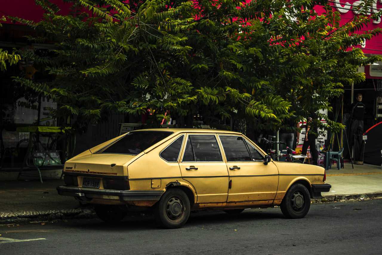 Yellow Oldtimer Car on a Street | Goodwill Car Donations