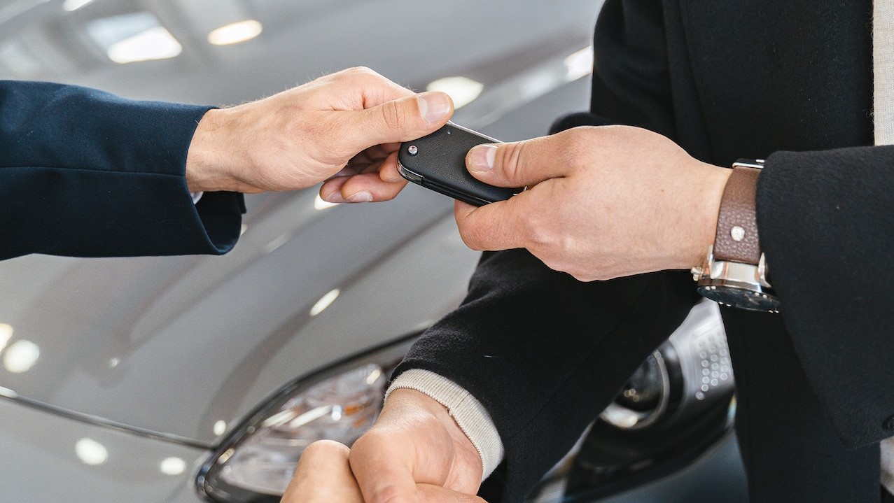 Handing in Keys to a New Car at the Car Salon | Goodwill Car Donations