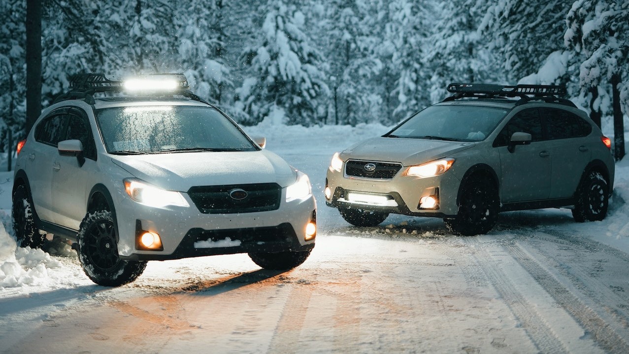 Two White Suvs on Snow-covered Road | Goodwill Car Donations