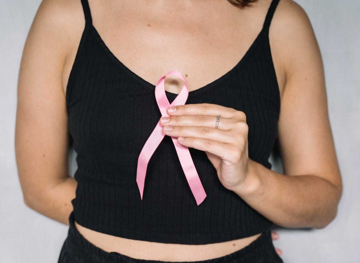 Woman Holding a Pink Ribbon | Goodwill Car Donations