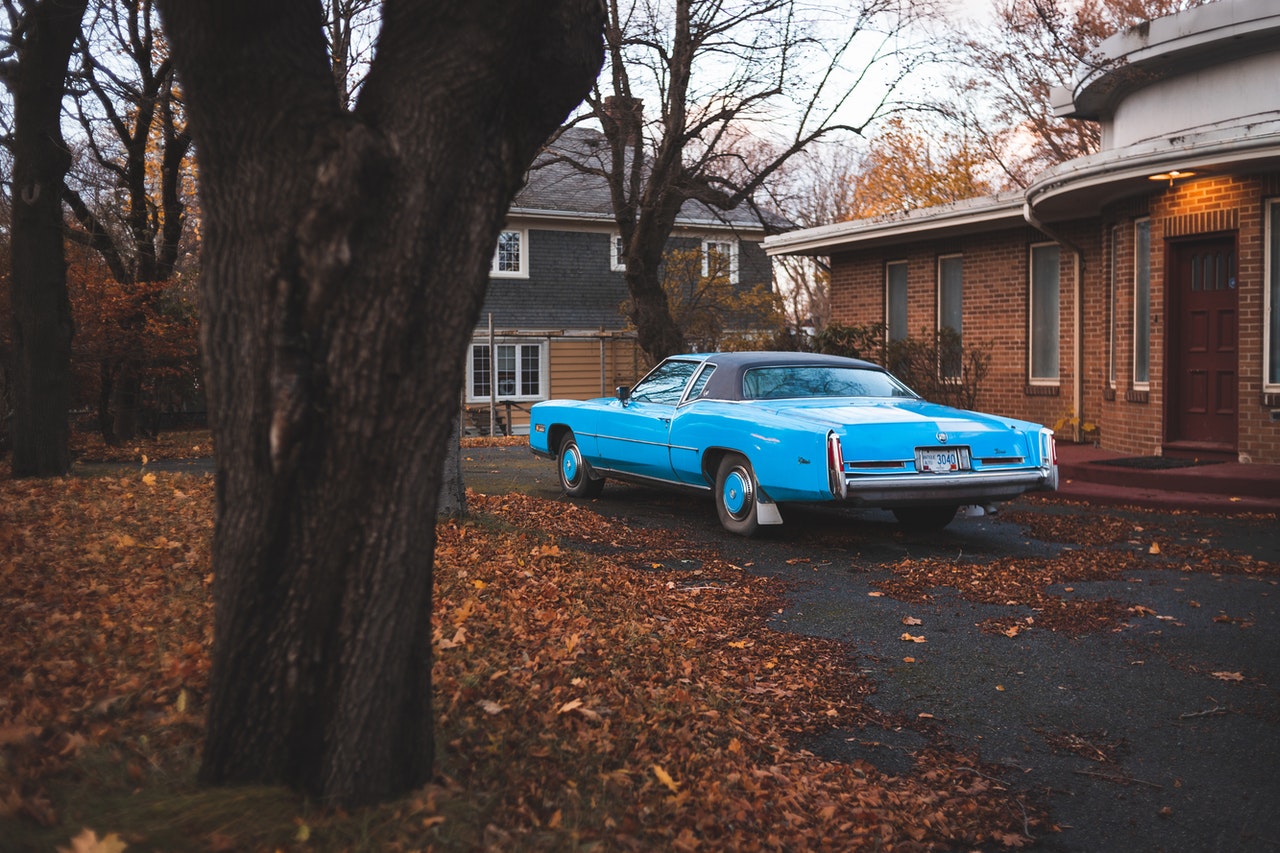 Blue Car Parked Outside the House | Goodwill Car Donations