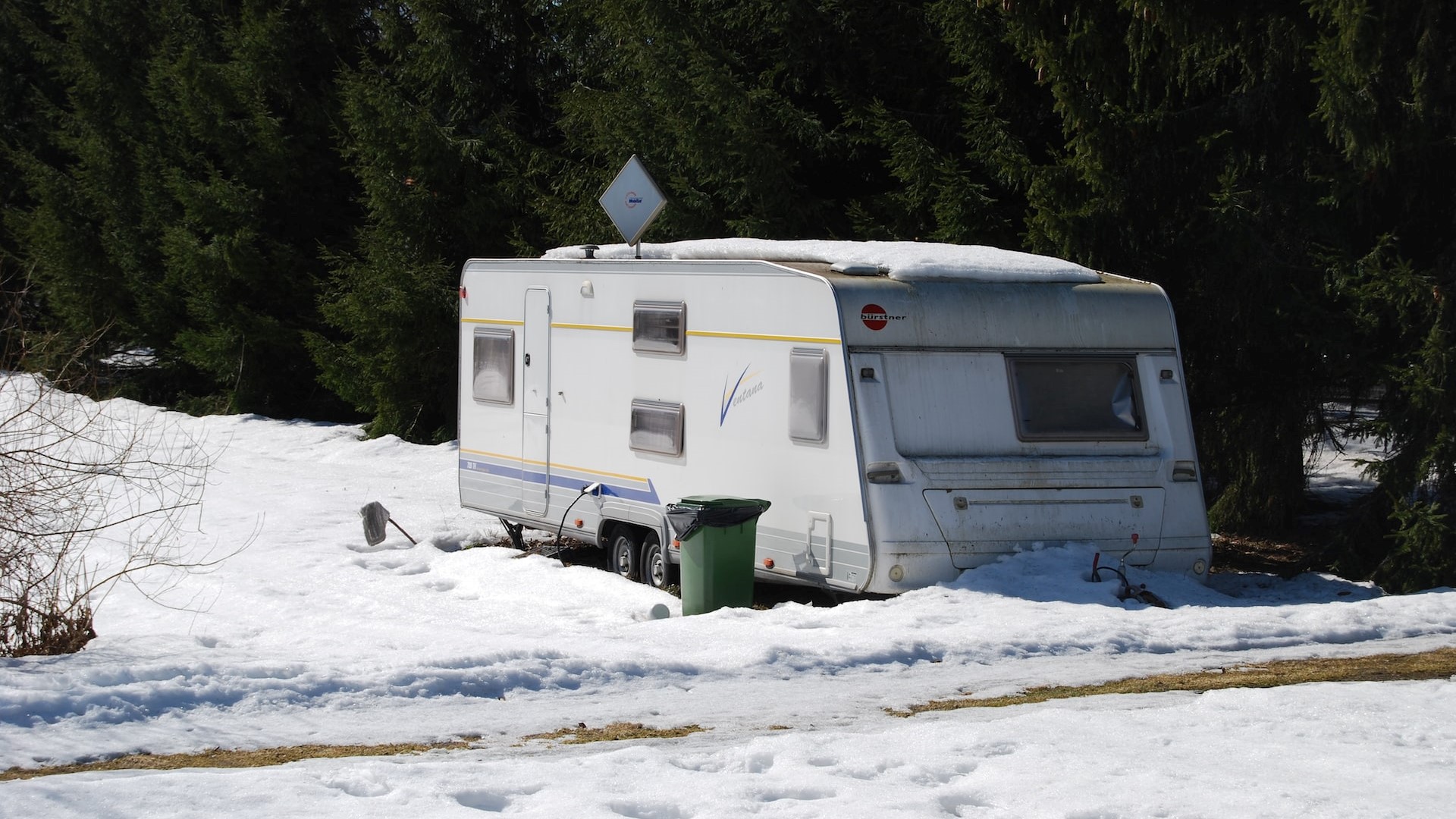 White rv trailer in a snowy field | Goodwill Car Donations