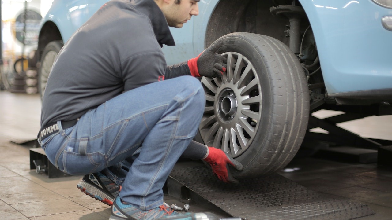 Man Changing a Car Tire | Goodwill Car Donations