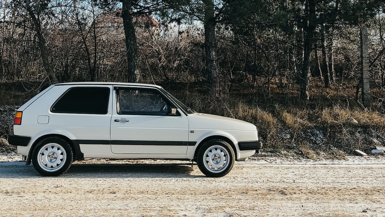 White Car on Dirt Road | Goodwill Car Donations