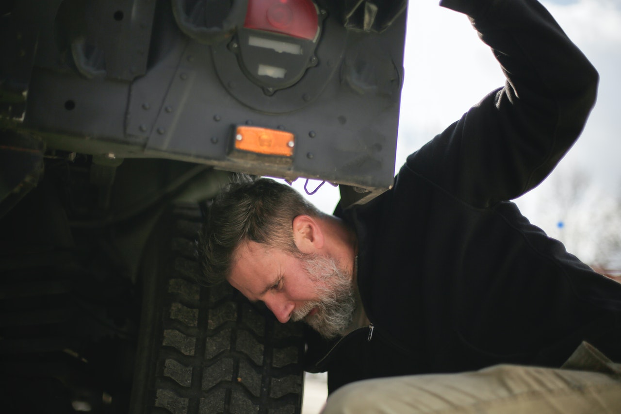 Man Fixing Car Tire | Goodwill Car Donations