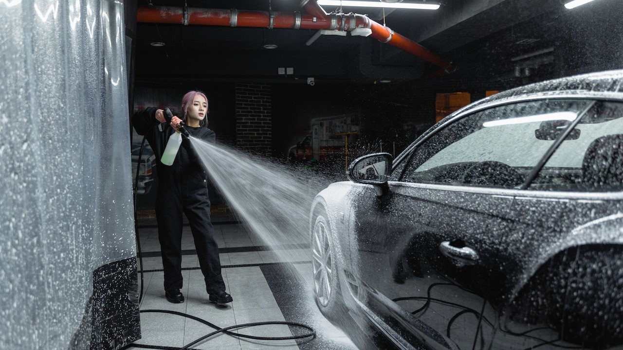 Woman washing car | Goodwill Car Donations