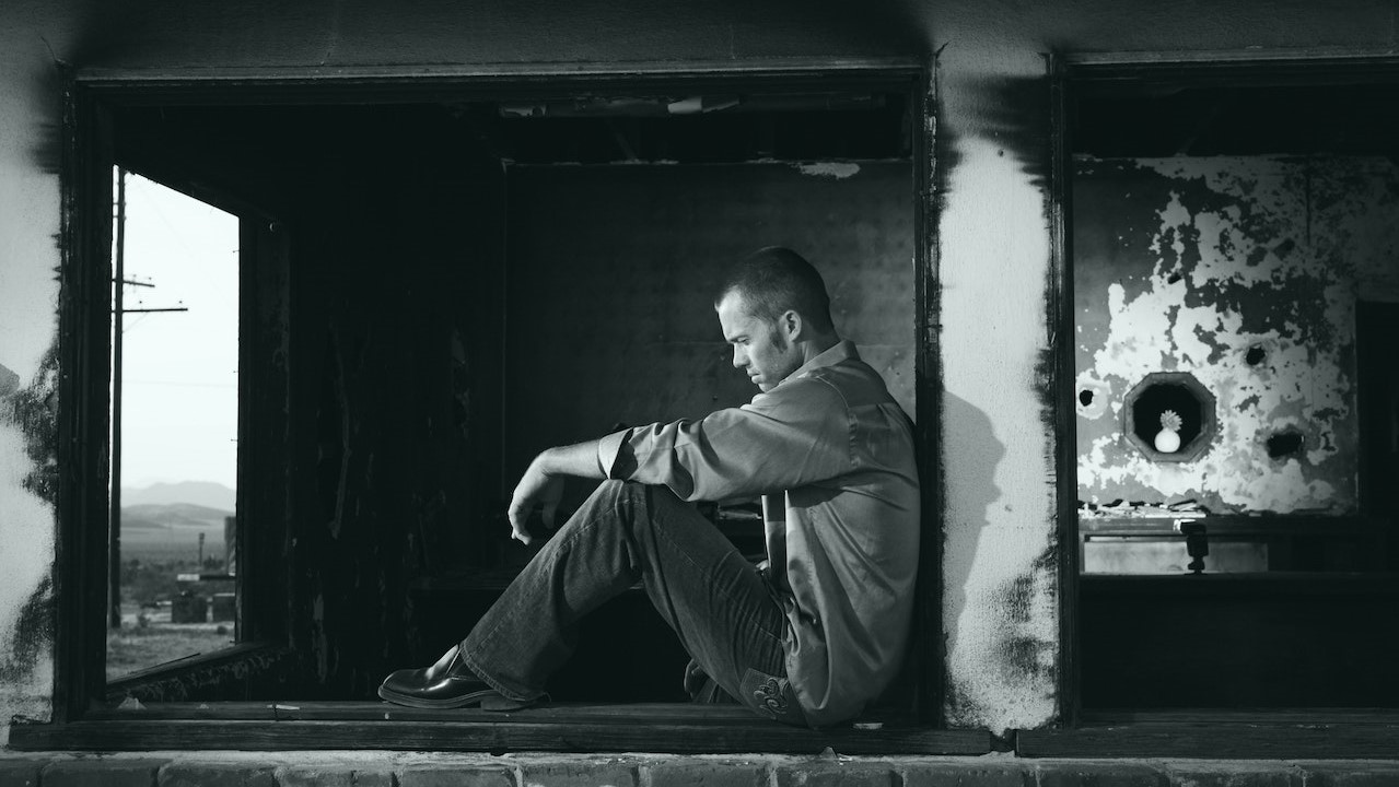 Grayscale Photo of Man Sitting | Goodwill Car Donations