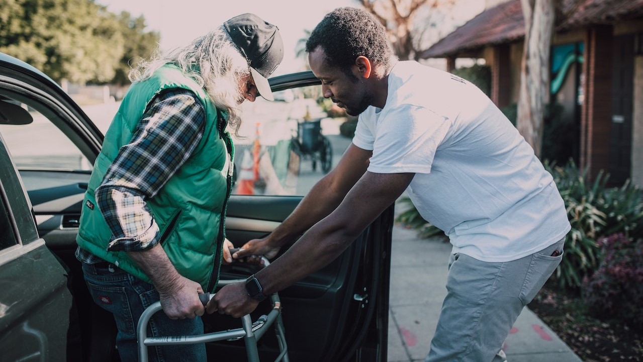 Man helping a person | Goodwill Car Donations