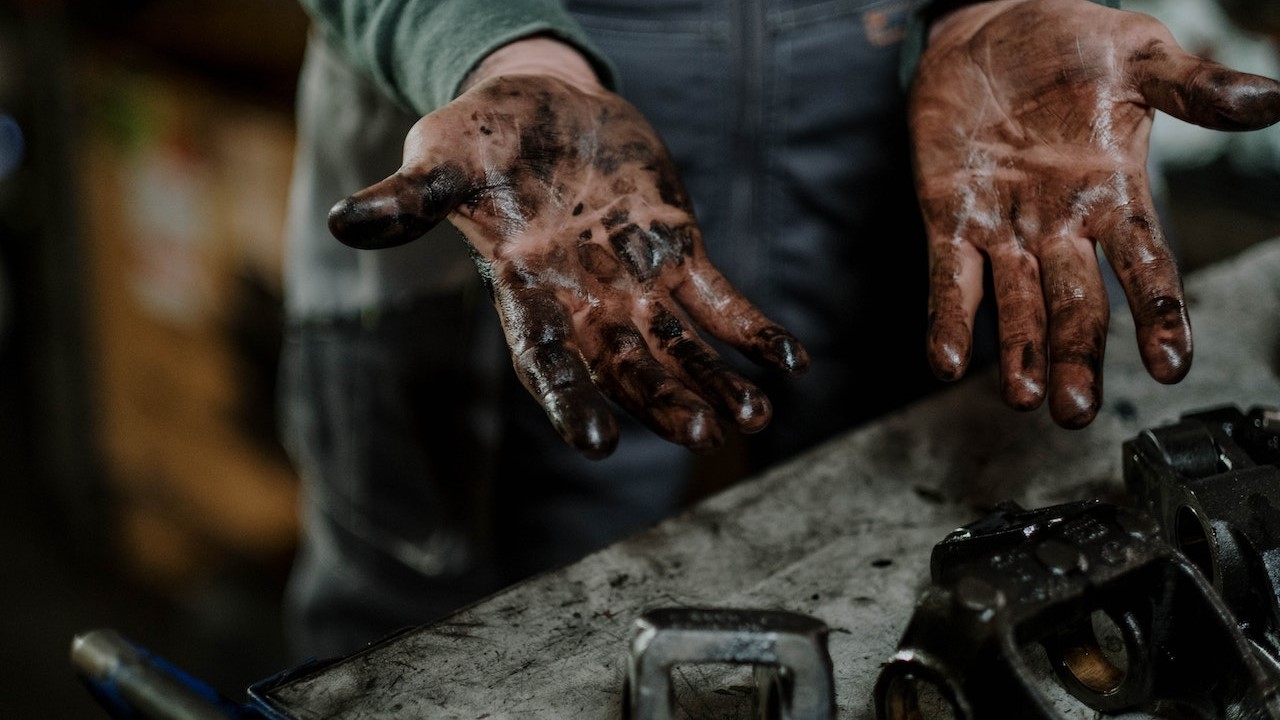 Hand full of grease | Goodwill Car Donations