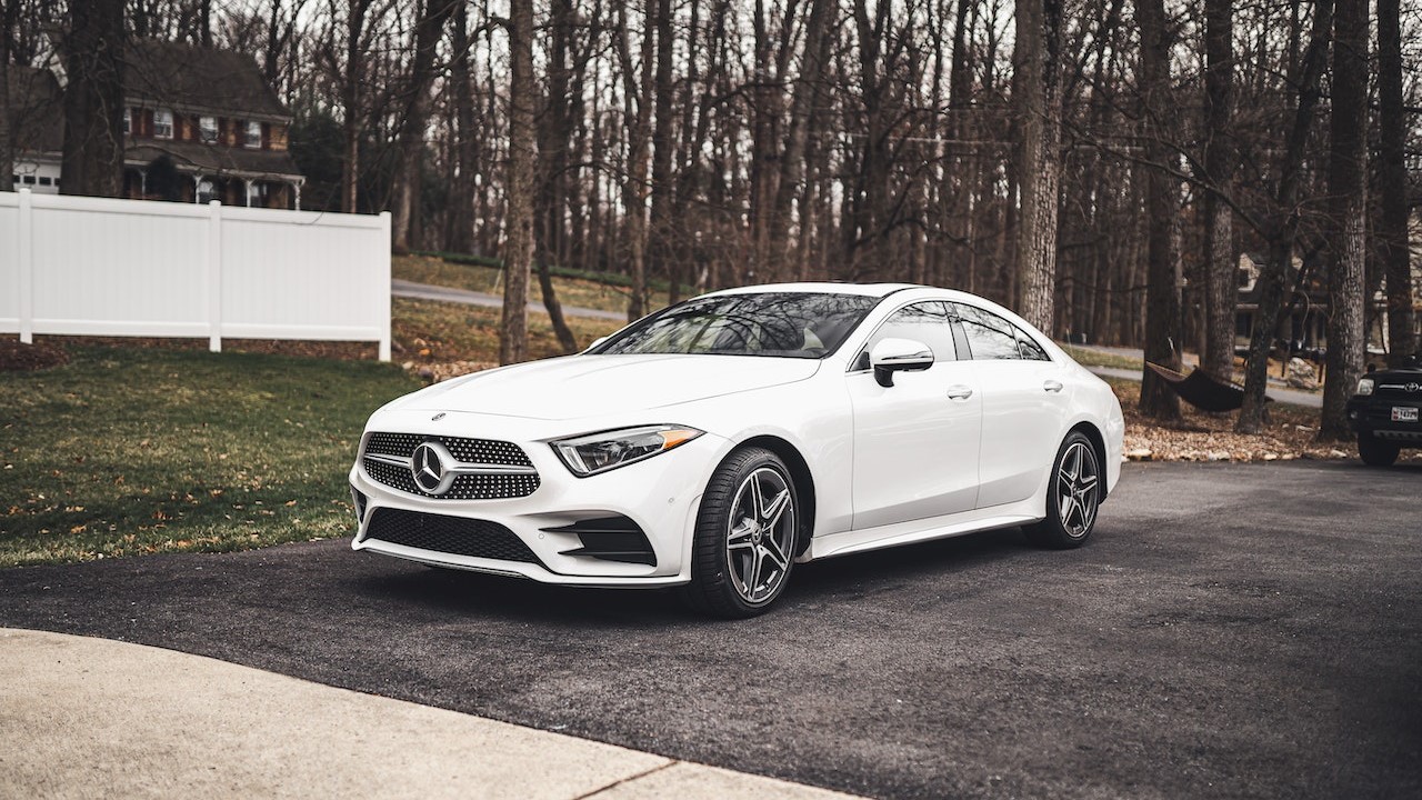 White Mercedes-Benz Sedan Parked on Pavement | Goodwill Car Donations