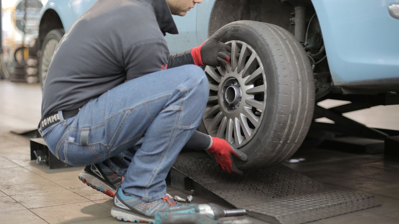 Man Changing a Car Tire | Goodwill Car Donations