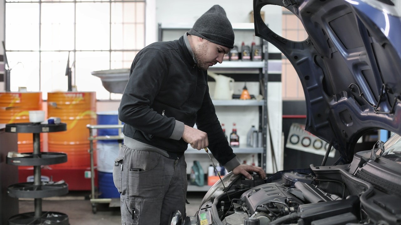 Photo of Man Inspecting Car Engine | Goodwill Car Donations