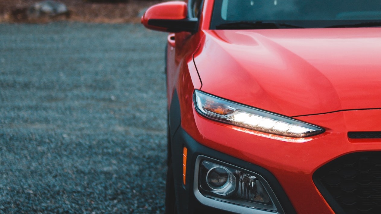 Red car parked on asphalt road | Goodwill Car Donations