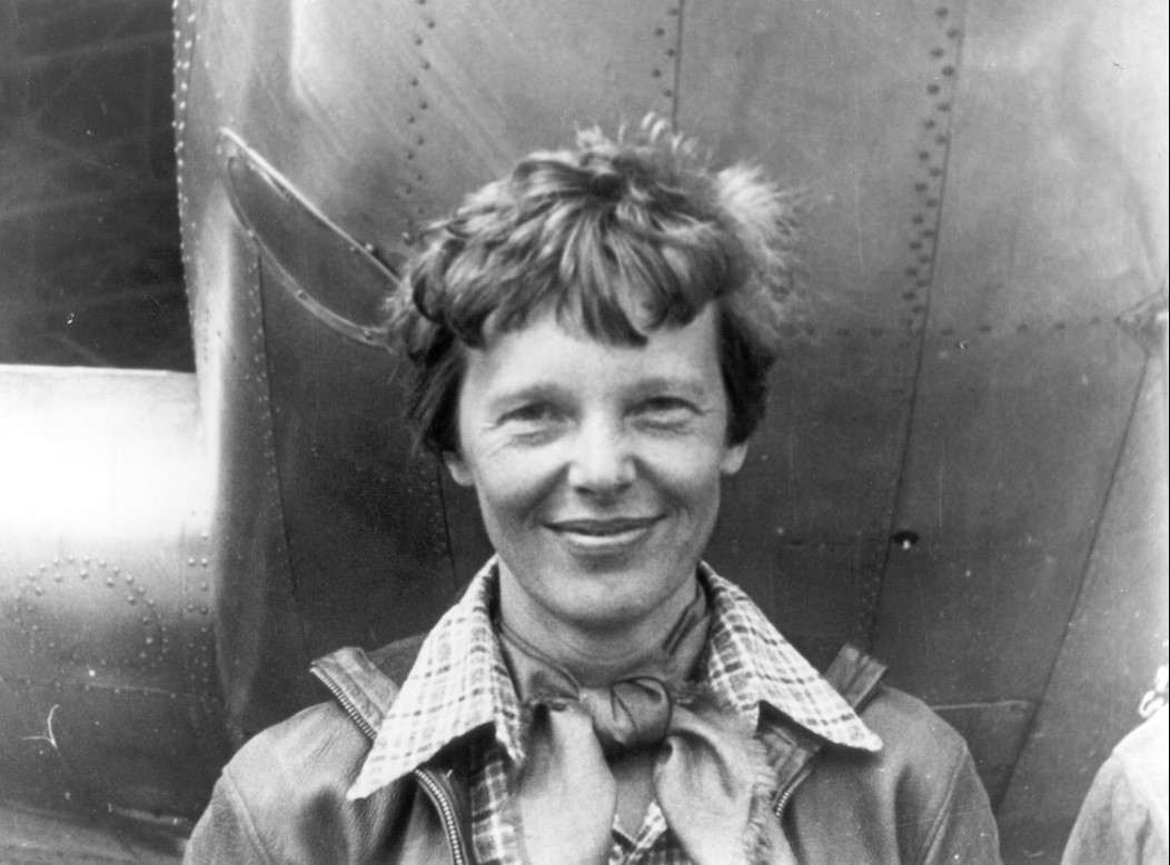 Amelia Earhart standing under nose of her Lockheed Model 10-E Electra | Goodwill Car Donations