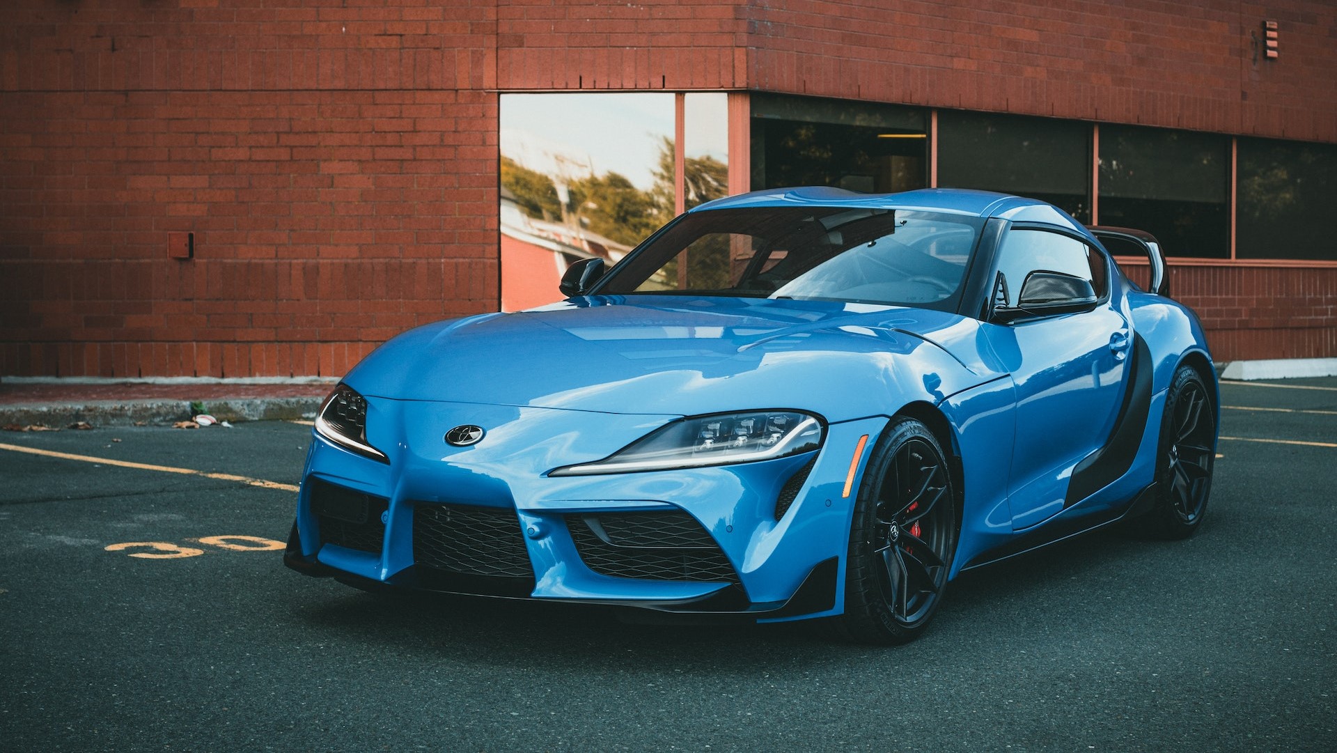 Blue Sports Car Parked Near Brick Building | Goodwill Car Donations