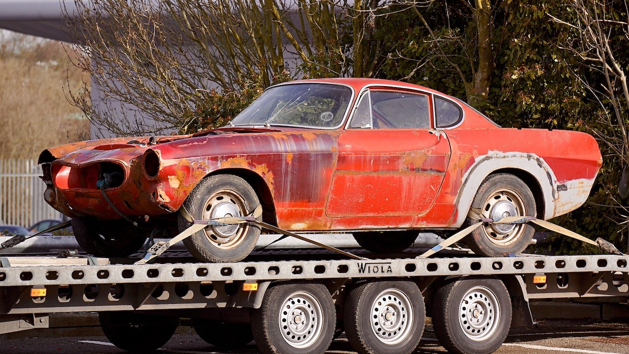 Red Coupe on Flatbed Trailer | Goodwill Car Donations