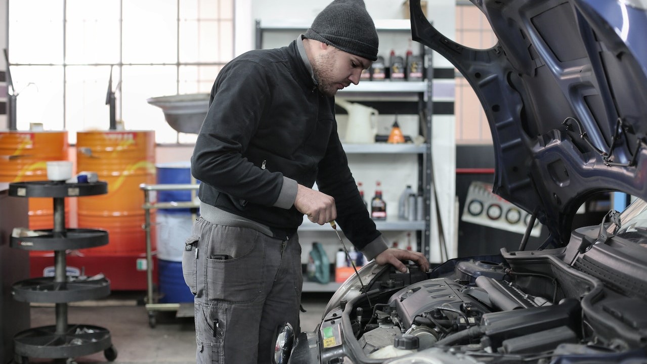 Photo of Man Inspecting Car Engine | Goodwill Car Donations