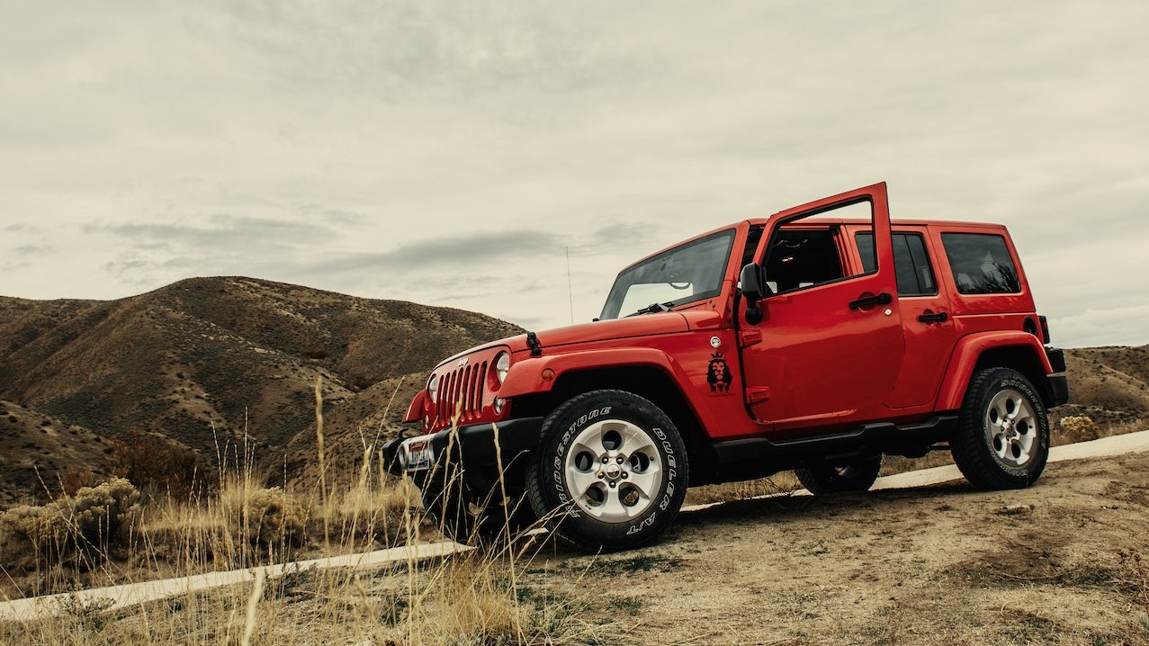 Photo of Red SUV On Dirt Road | Goodwill Car Donations