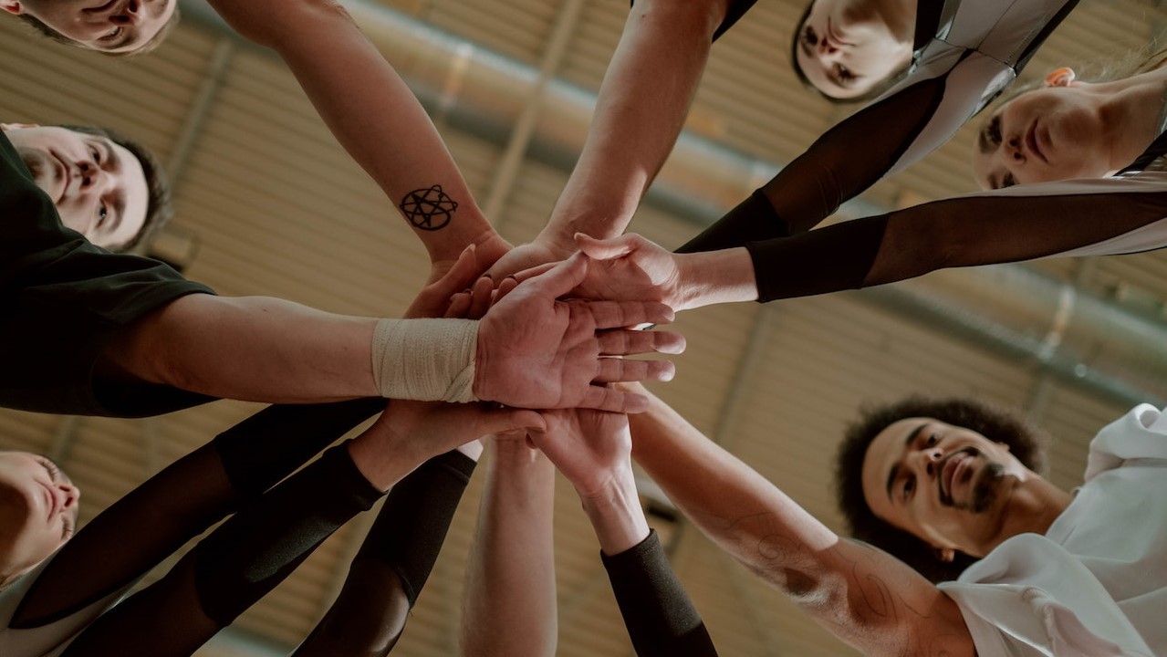 Group of People Joining Hands Together | Goodwill Car Donations