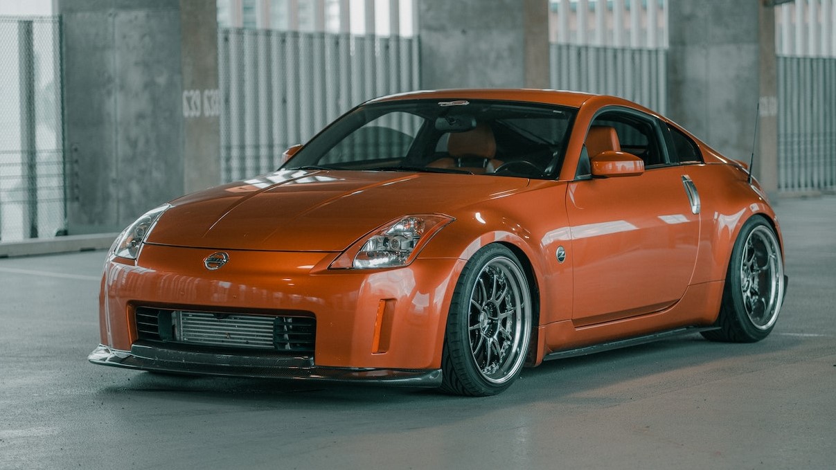 Orange Sportscar Parked at a Garage | Goodwill Car Donations