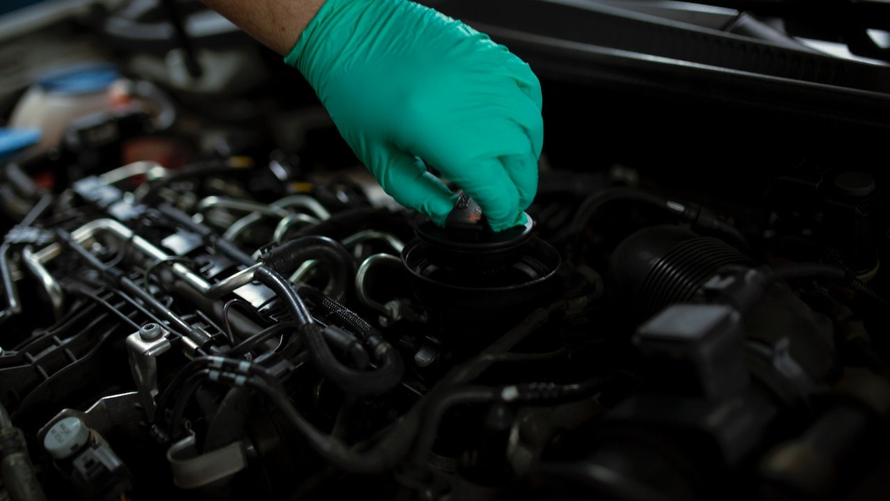 Person opening the oil filler cap | Goodwill Car Donations