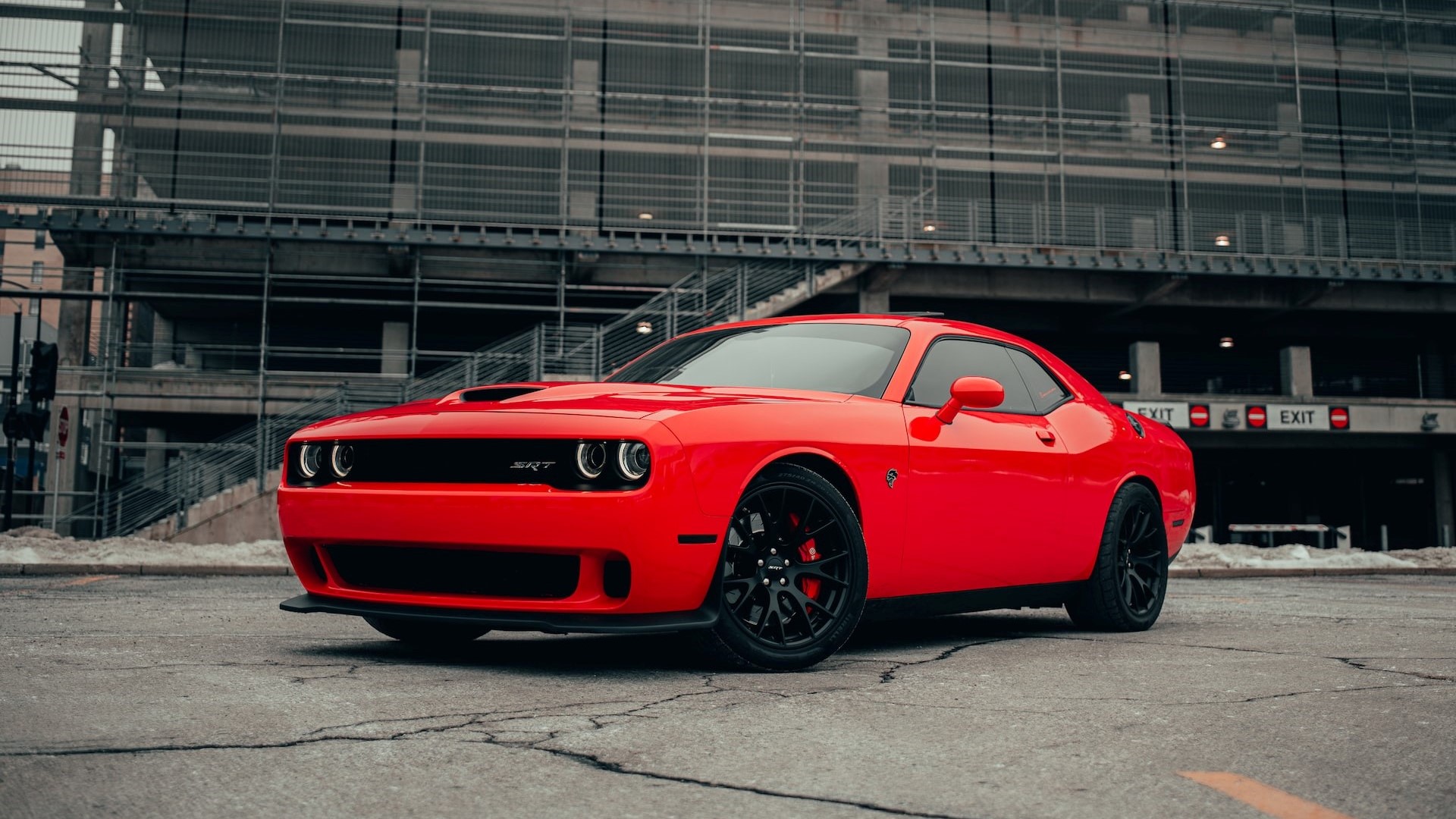 Red coupe parked near a building | Goodwill Car Donations