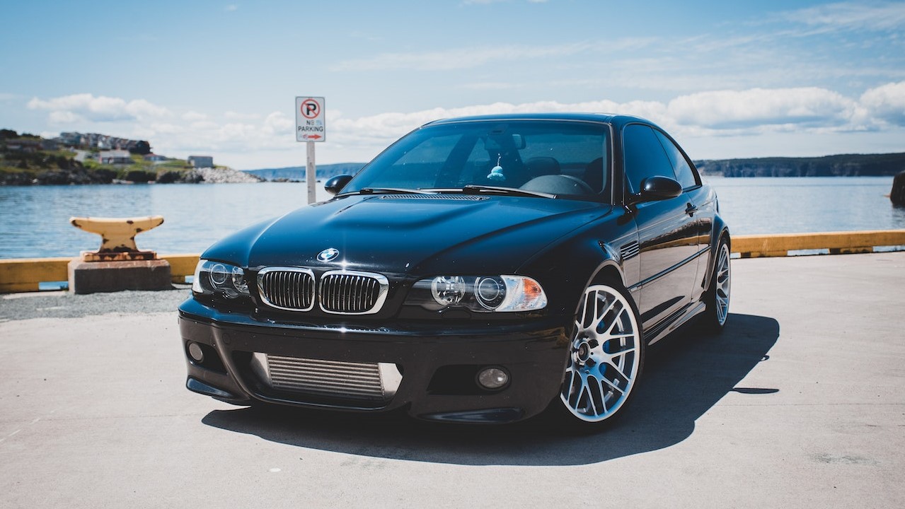 Black BMW Car on Gray Concrete Road | Goodwill Car Donations