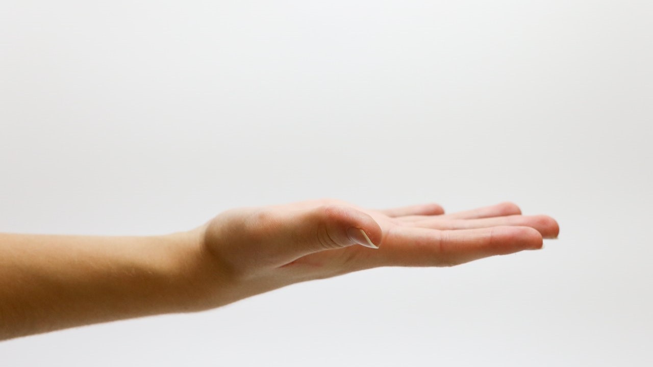 Close-up of Hand over White Background | Goodwill Car Donations