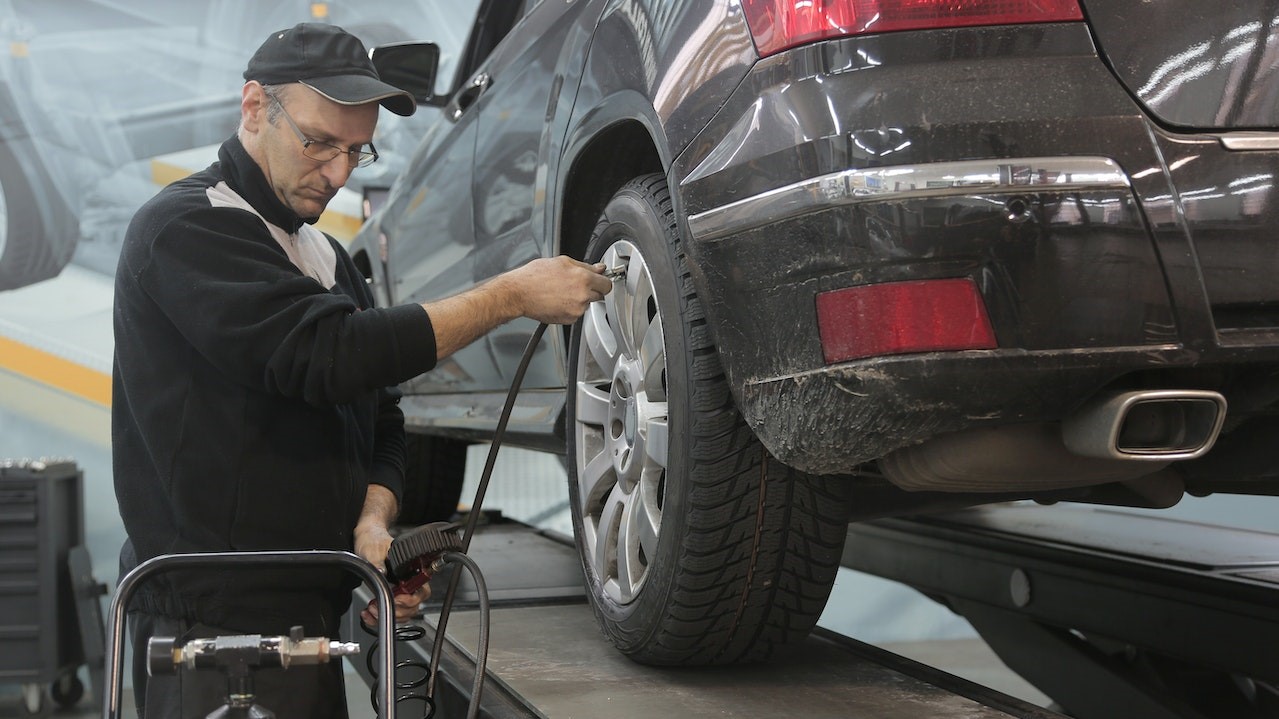 Man checking his car tire | Goodwill Car Donations