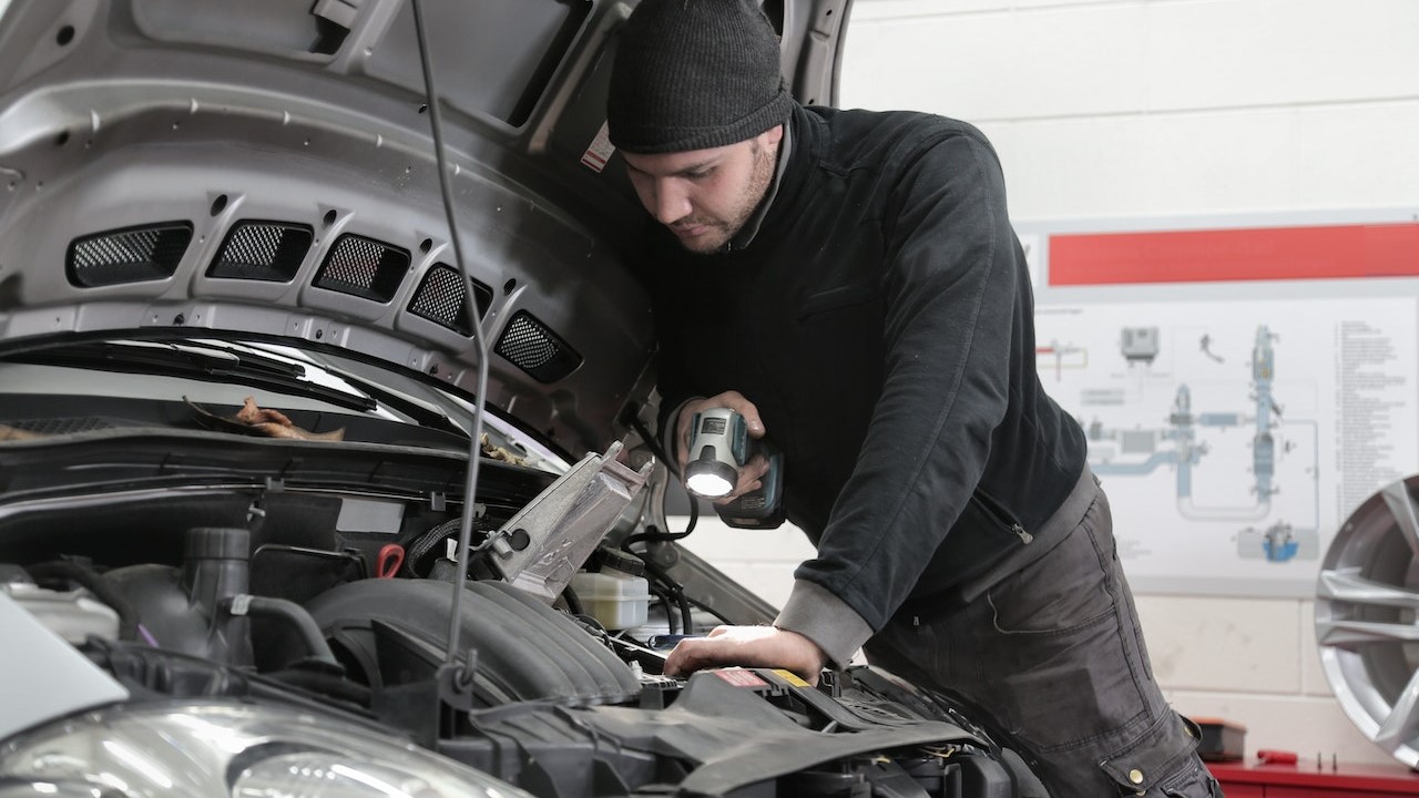 Man checking the engine of a car | Goodwill Car Donations