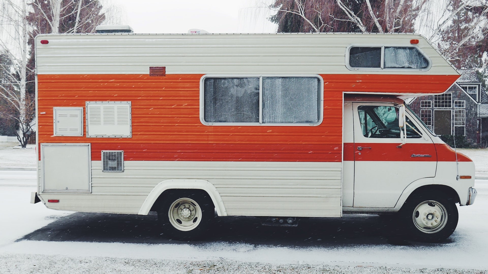 Orange and White RV by Snow | Goodwill Car Donations