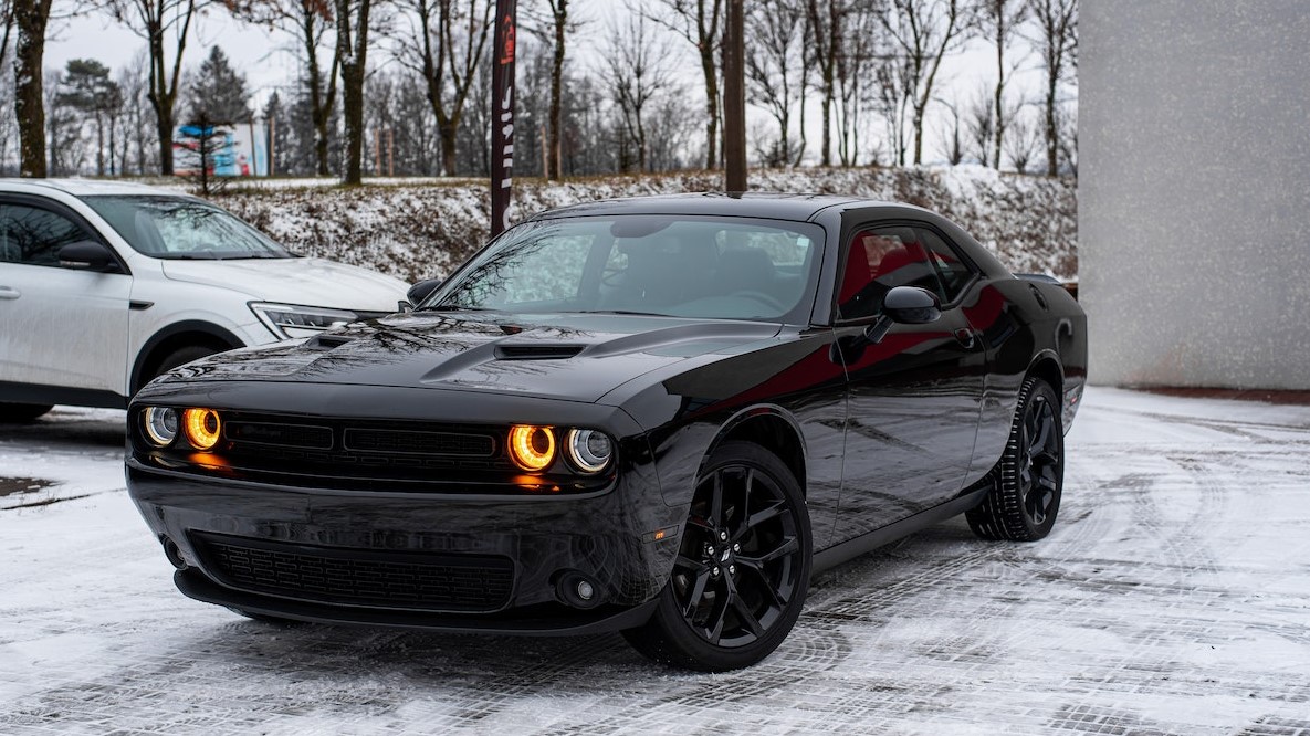 A Black Dodge Car Parked on a Snow Covered Ground | Goodwill Car Donations