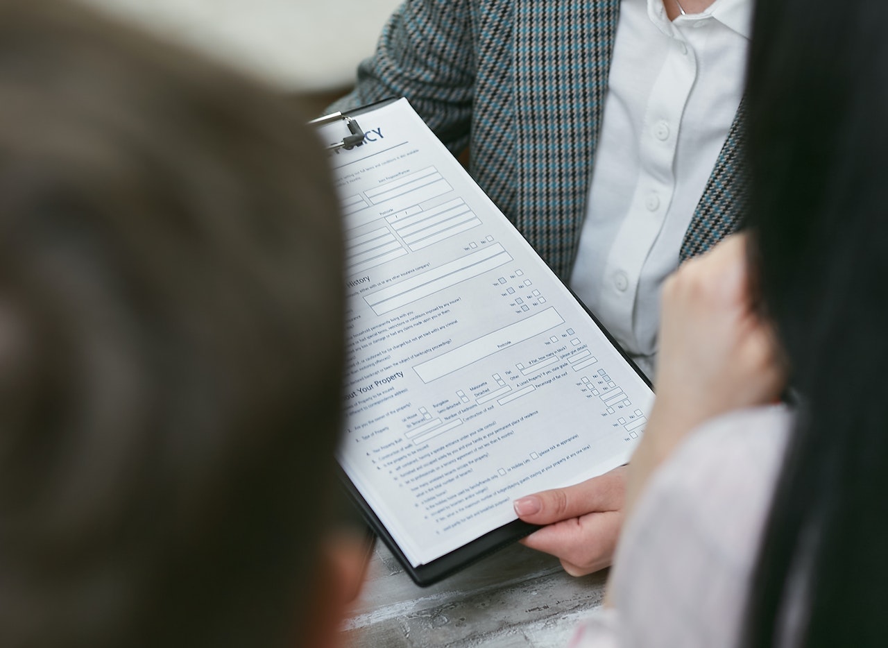 A Person Holding a Contract Document | Goodwill Car Donations