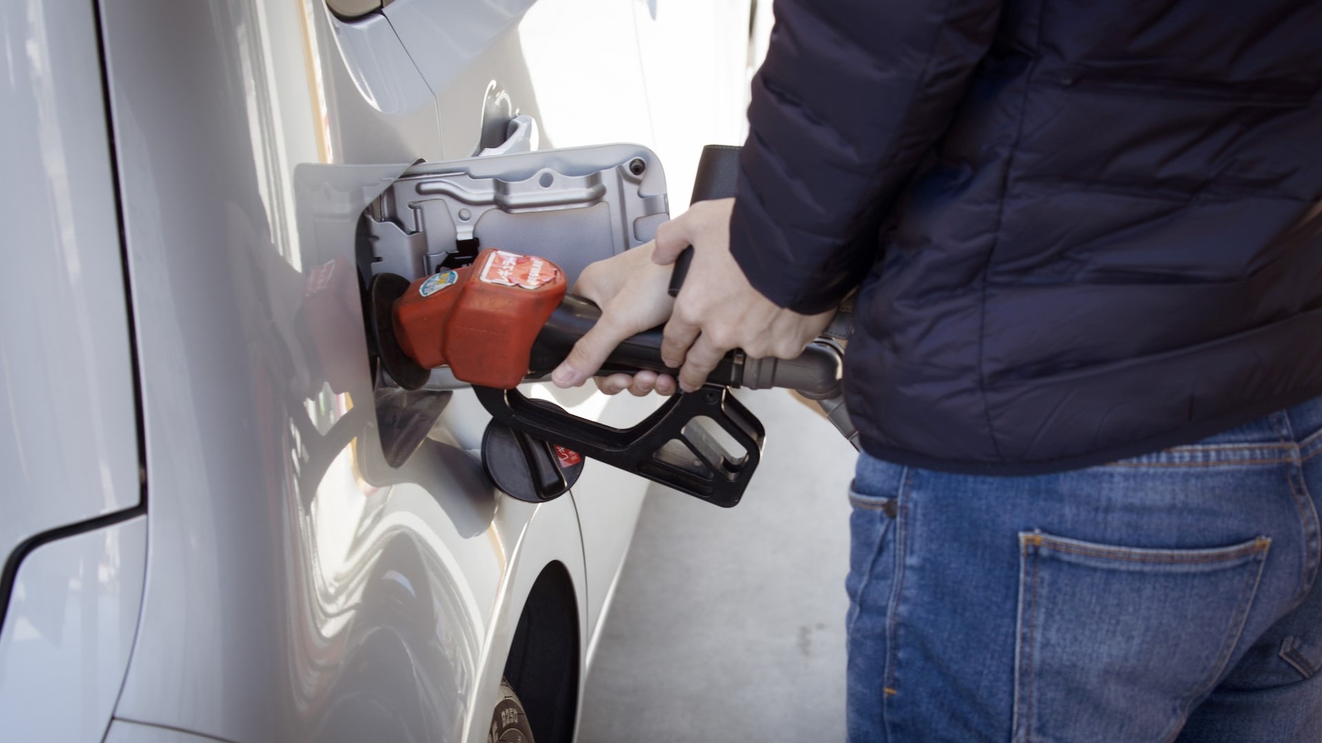 Man holding a gas pump | Goodwill Car Donations