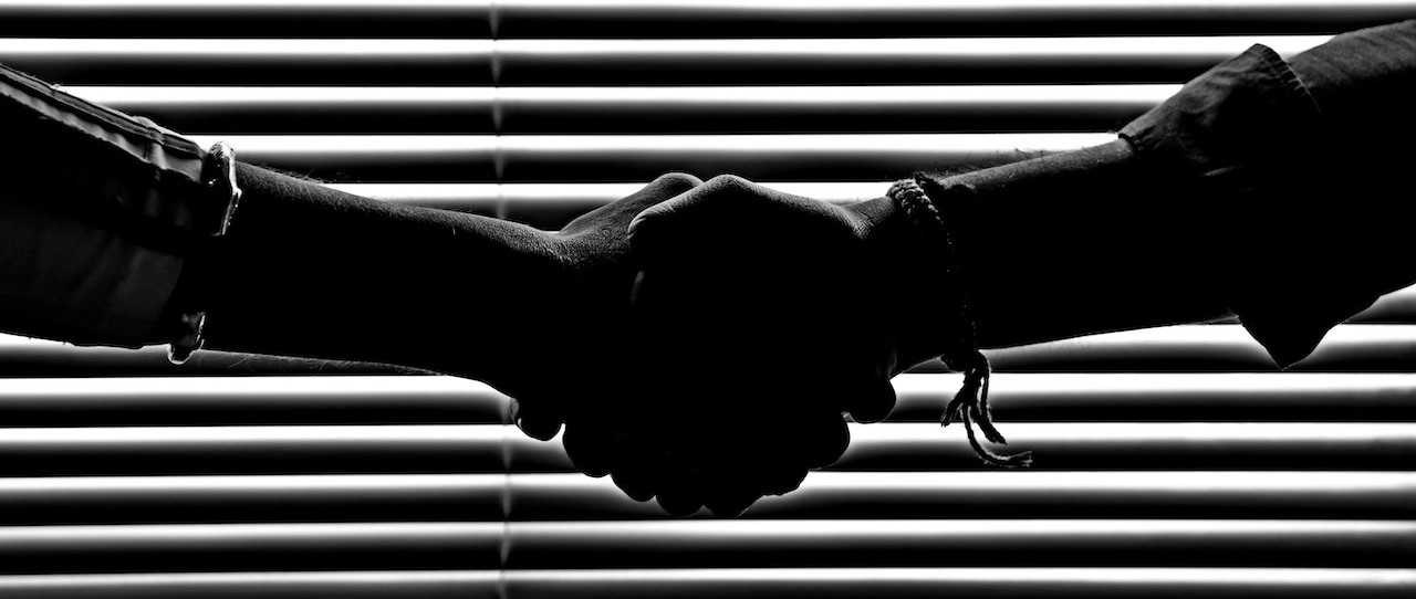 Monochrome Photography of People Shaking Hands | Goodwill Car Donations