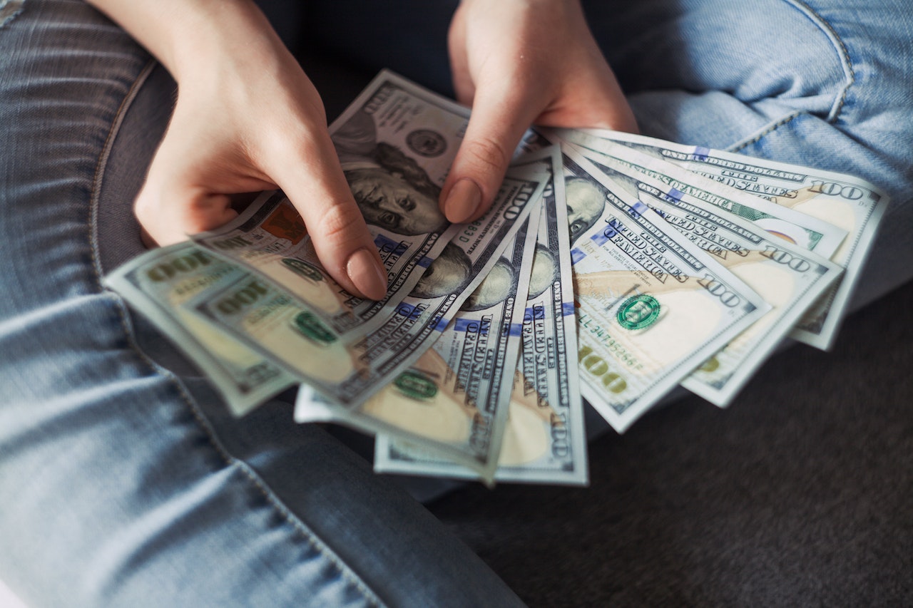 Person Holding 100 Us Dollar Banknotes | Goodwill Car Donations
