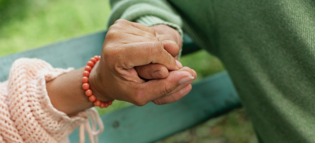 Photo of Two Holding Hands | Goodwill Car Donations