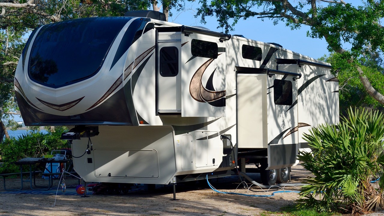 5th wheeler rv parked near the trees | Goodwill Car Donations