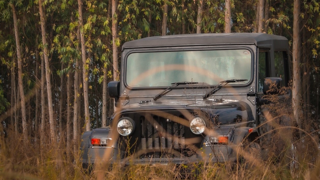 Black jeep in grass | Goodwill Car Donations