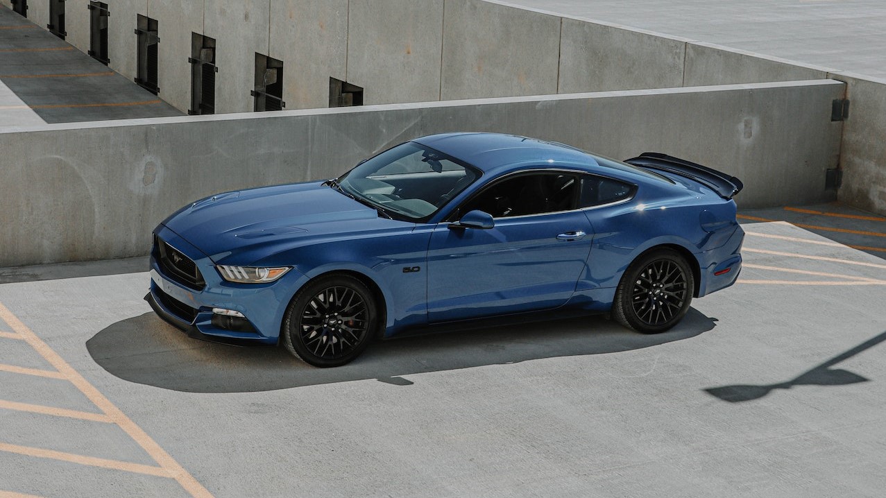 Blue Coupe Parked on Gray Concrete Parking Lot | Goodwill Car Donations