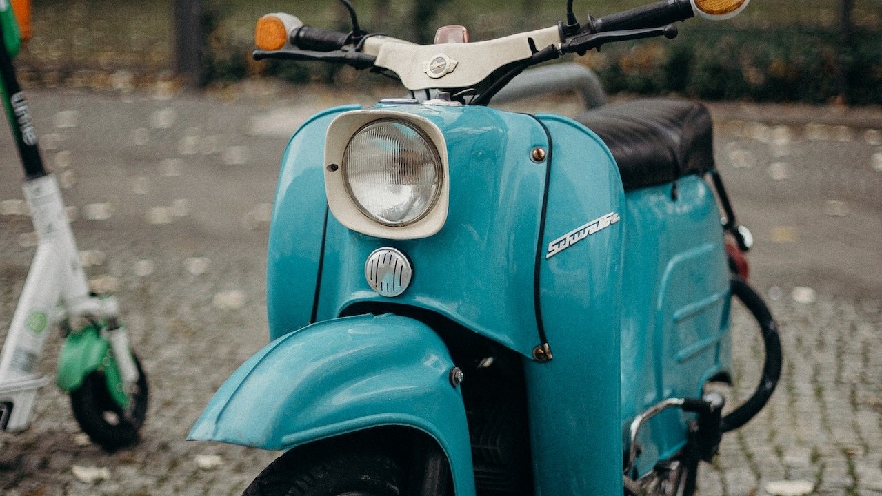 Blue scooter on the sidewalk | Goodwill Car Donations