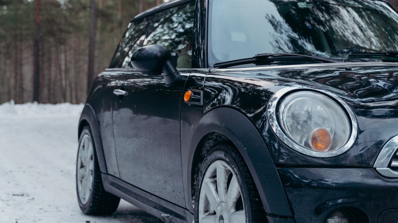 Close-Up Shot of a Black Car on Snowy Ground | Goodwill Car Donations