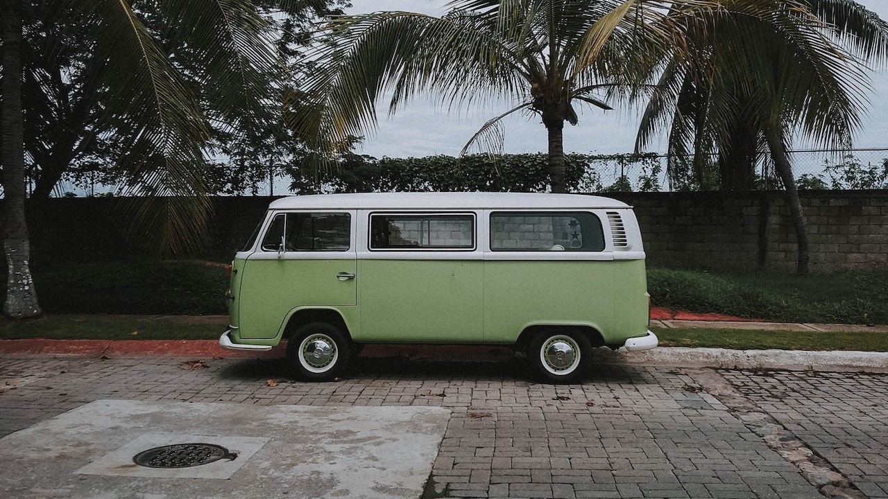 Green volkswagen van parked near a coconut tree | Goodwill Car Donations