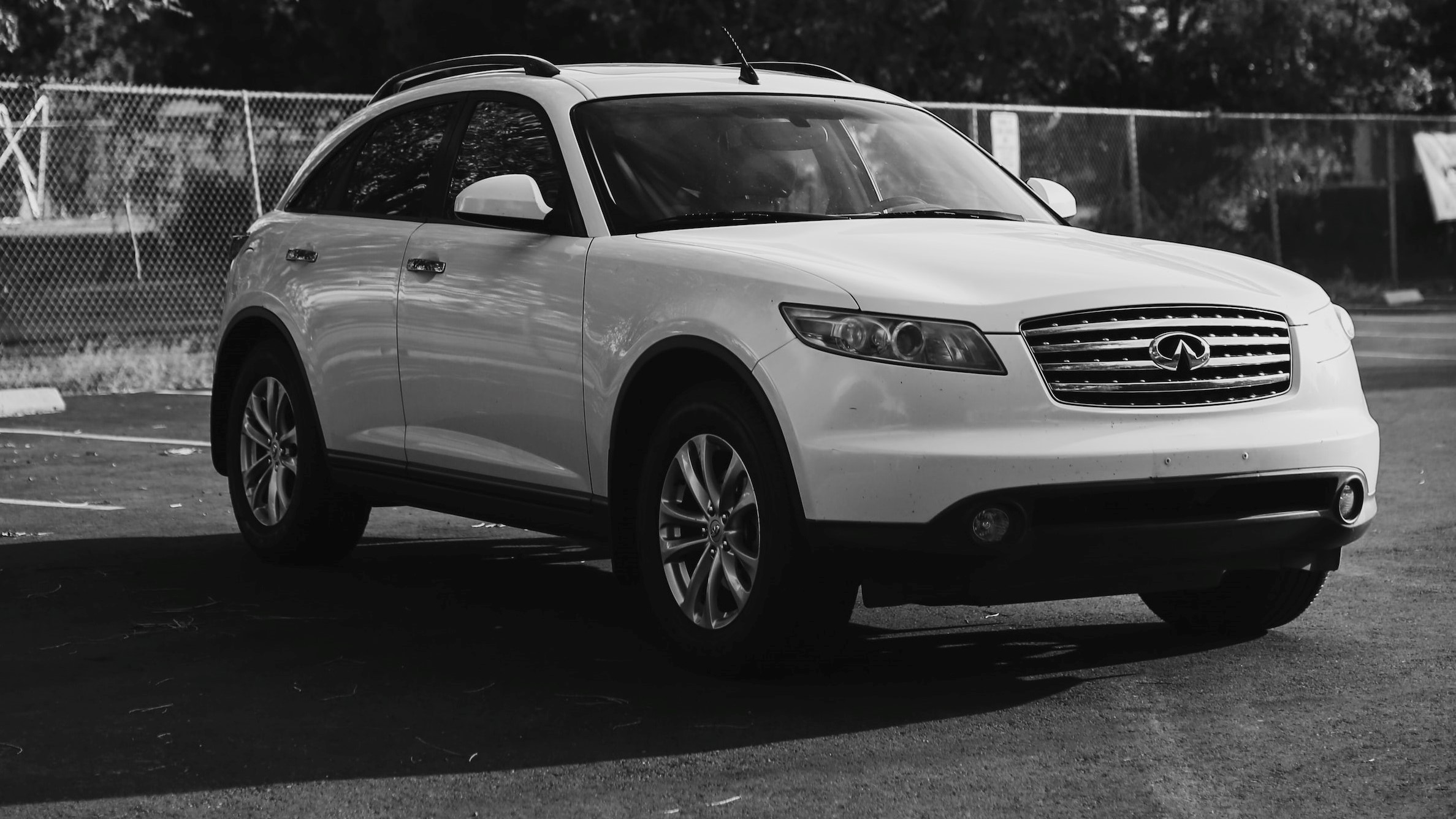 Greyscale photo of white SUV | Goodwill Car Donations