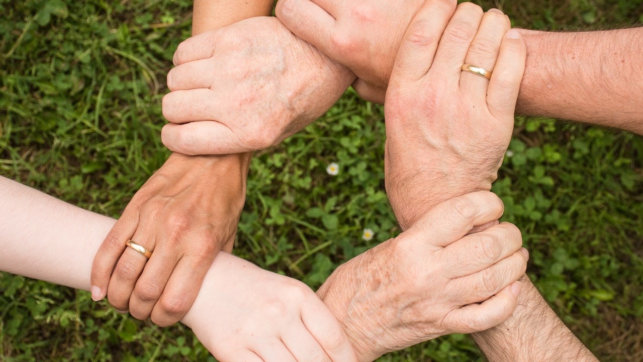 Group of People Holding Arms | Goodwill Car Donations